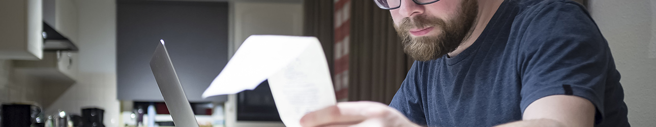 man looking at a receipt