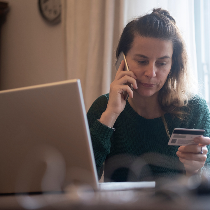 Woman on the phone holding gift card