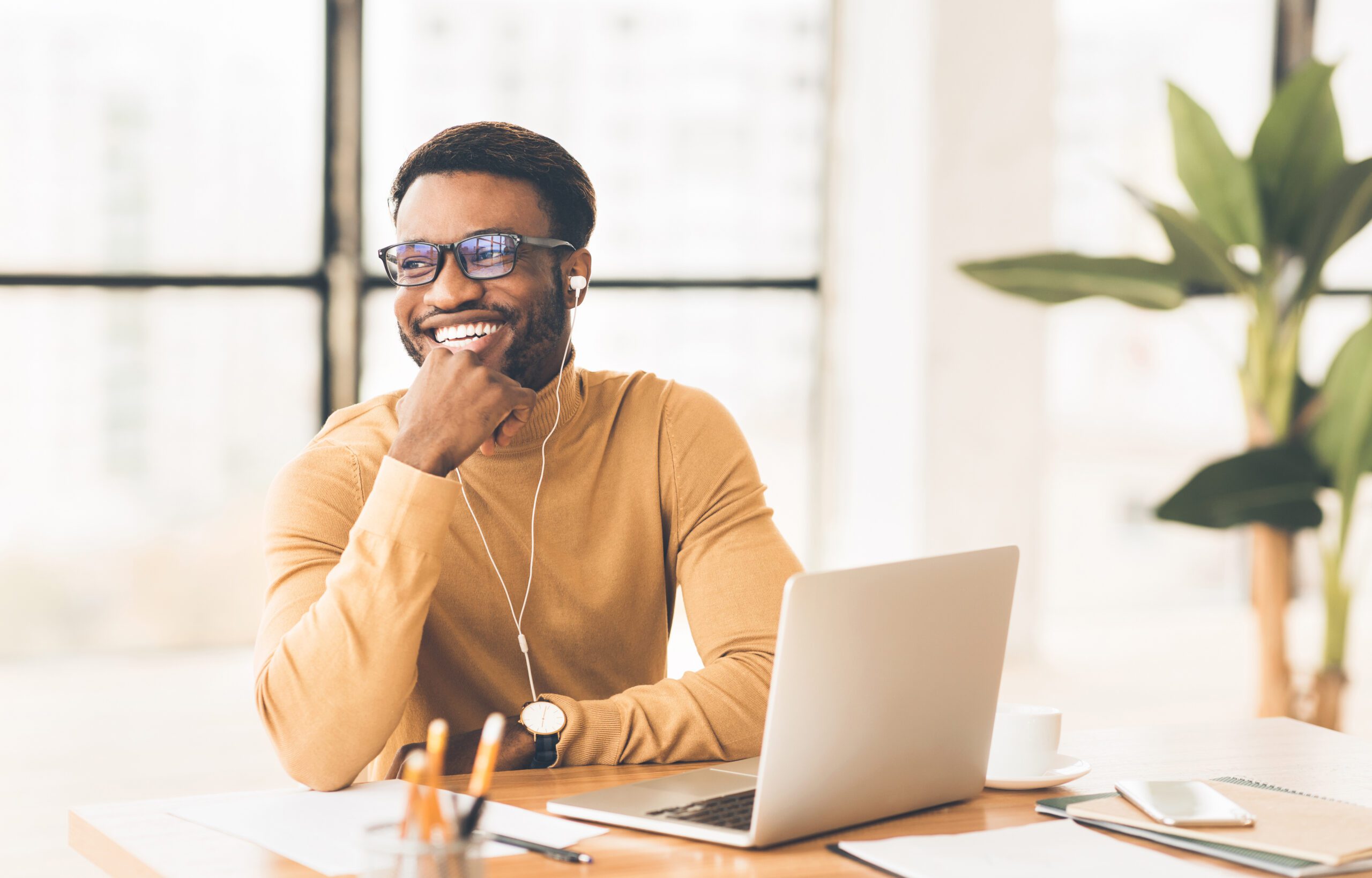 Young smiling man at a laptop