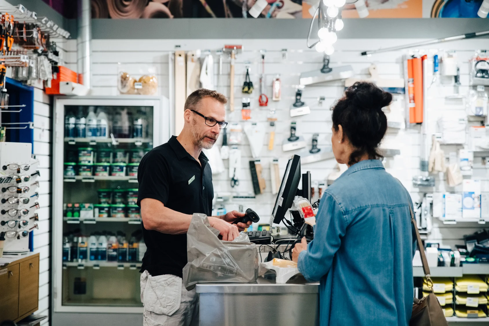 Cashier at a hardware store handling a customer return.