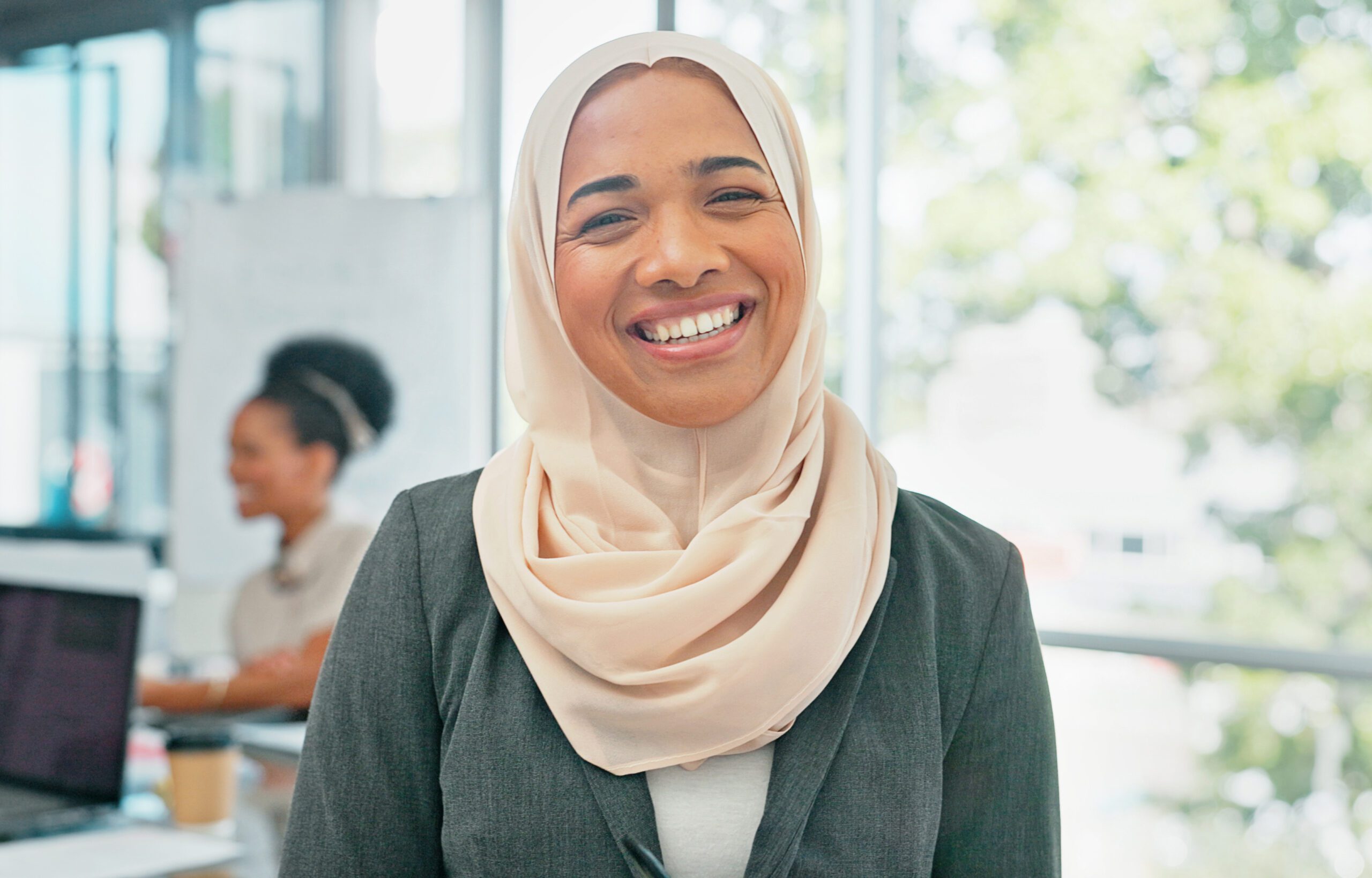 A business woman in her office at work wearing a hijab