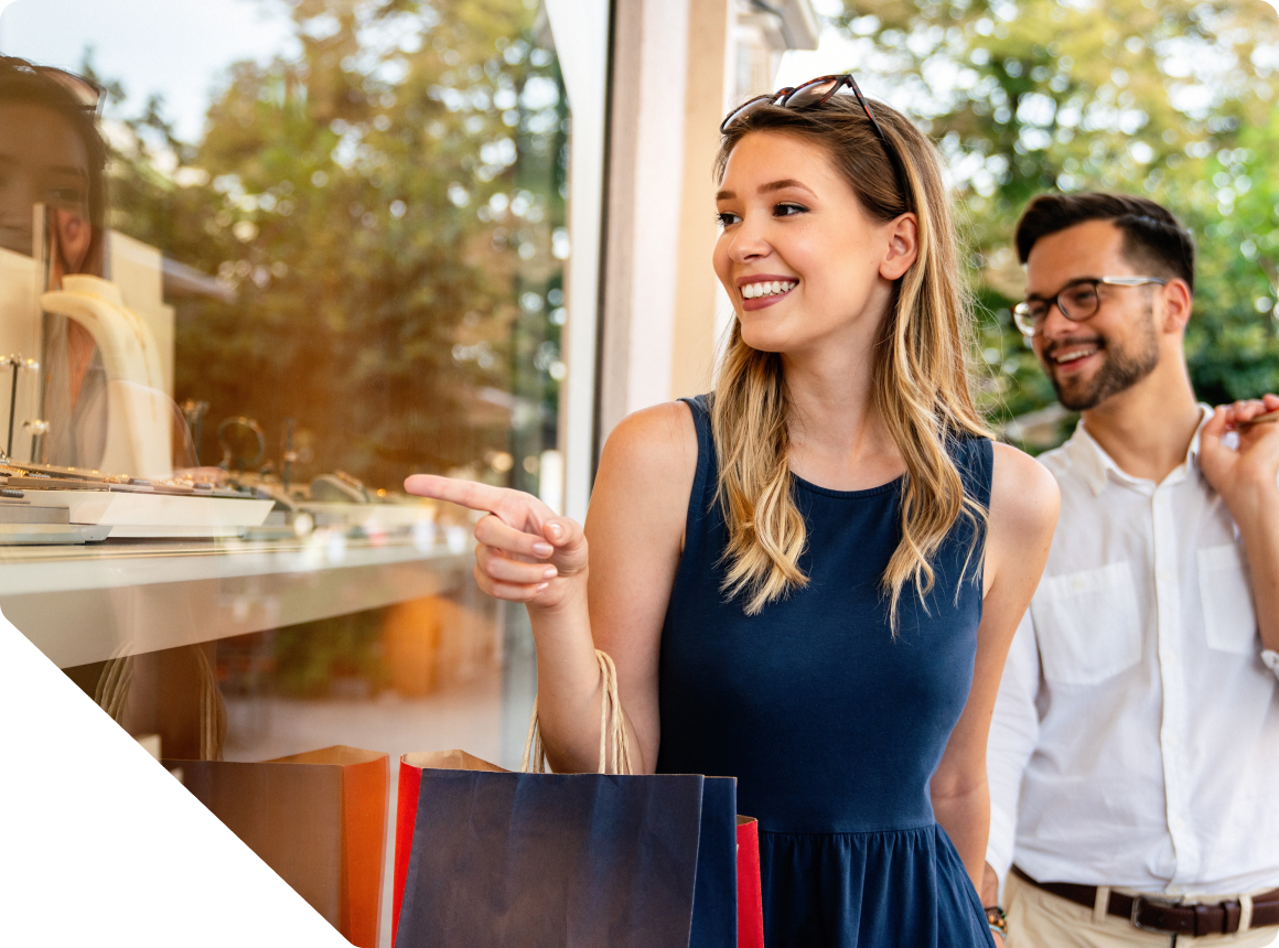 Engage Incentive Optimization Woman shopping and pointing to a window