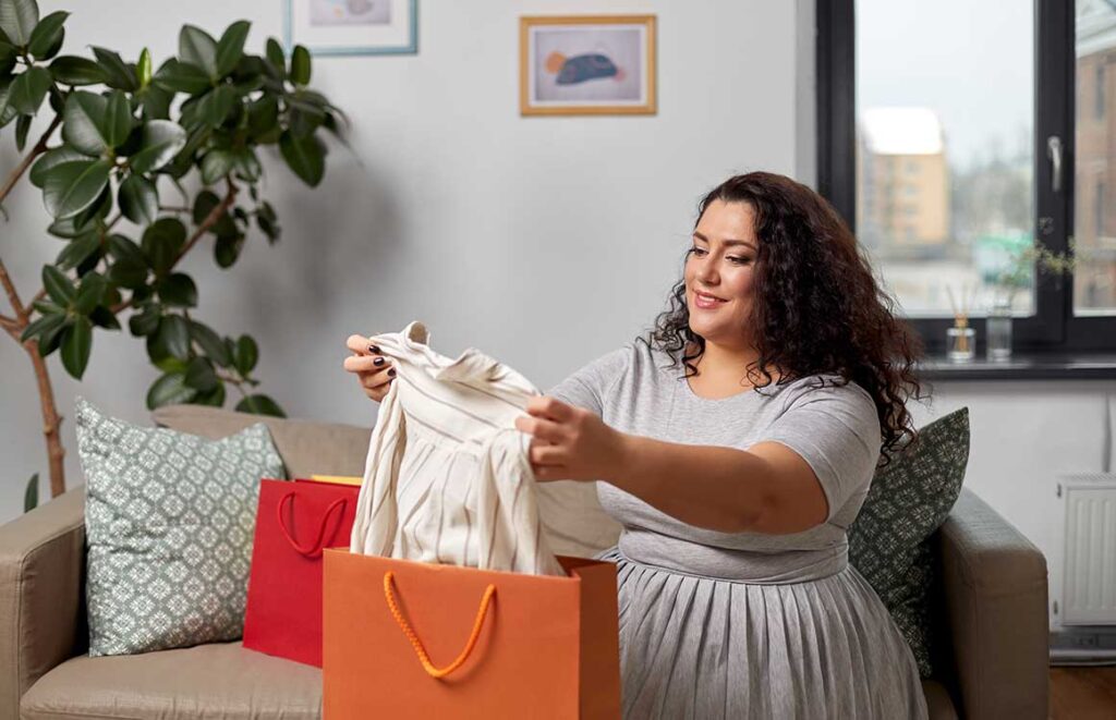 woman opening shopping bag at home dynamic policies
